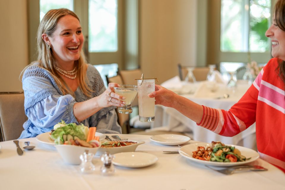 Guests enjoying food and drinks at Audubon Clubhouse