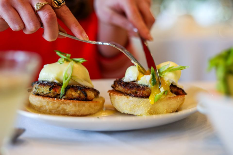 A guest cutting their food at Audubon Clubhouse