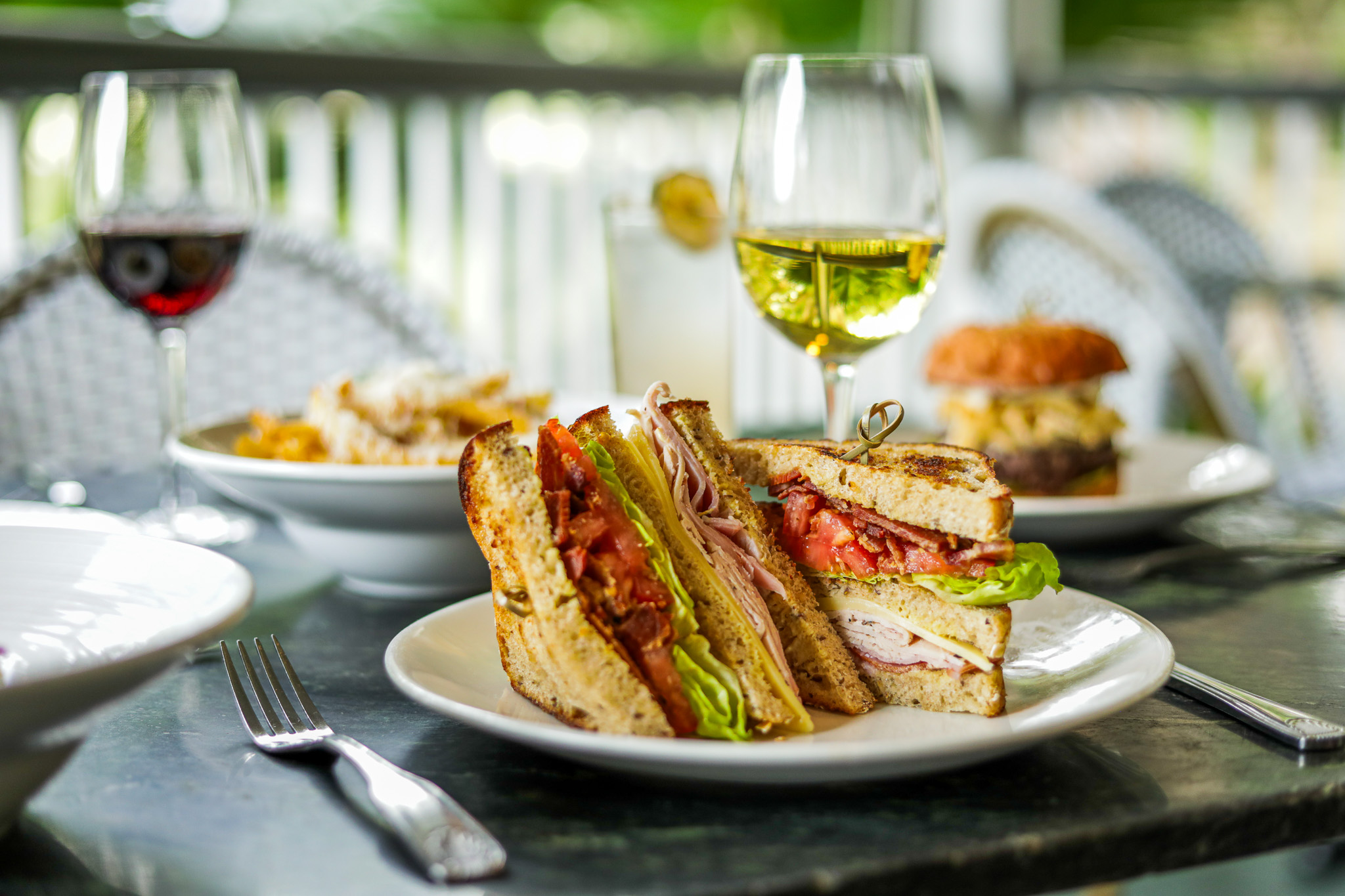 A sandwich and glasses of wine at Audubon Clubhouse